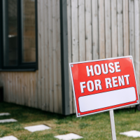 House for rent sign in front of a house